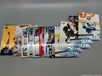 All 15 cards fanned, showing variety of Young Guns, Allure, Canvas, inserts