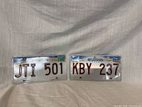 Front view of both New Brunswick license plates showing serials and stickers