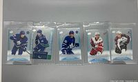 Front view of all five Clear Cut Phenoms cards in sleeves: Matthews, Pettersson, Marner, Larkin, MacKinnon