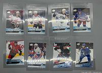 Fronts of all eight Young Guns cards in sleeves