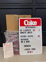 Front of Coca-Cola menu board with sample lettering, bag of letters, box and instruction sheet visible