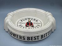 Top angled view showing exterior lettering 'FLOWERS BEST BITTER' and overall form