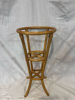 Front view of bamboo and rattan plant stand showing full structure