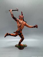 Full view of figure in running pose showing paint wear