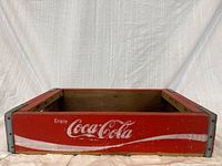 Top view of red Coca-Cola crate showing logo and open interior