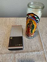 Incense box beside devotional candle