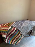 Both textiles draped over surface showing size and edge overlap