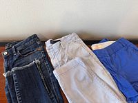 Three pairs of pants/shorts side by side