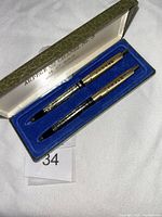 Open case showing both pens seated in blue insert