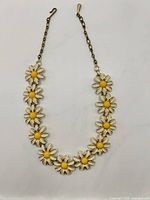 Front view showing enamel daisy motif and overall condition