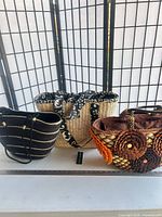 Group shot of the three straw tote handbags on table