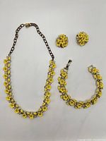 Full view of necklace, bracelet, earrings laid out