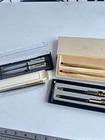 Overview of four boxed pen sets