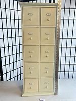 Full front view of cream wood organizer showing all ten drawers and overall height