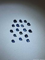 Group of round blue sapphires on white background