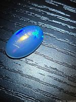 Top view showing entire oval cabochon and play of color