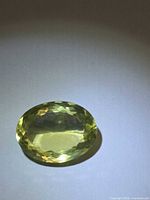 Top view of oval lemon citrine gemstone showing color and facet pattern