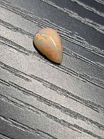 Top view of pear cabochon fire opal showing play of color