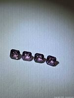 Four purple octagon spinels on neutral background
