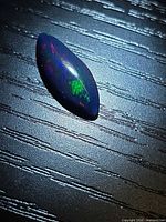 Marquise black opal showing green and blue fire