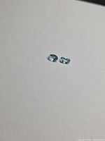 Top view of two oval aquamarines showing color and cut