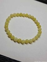 Full view of lemon jade bead bracelet on white background