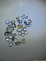 Group of loose multicolour faceted tanzanites on white background