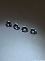 Four round pale blue aquamarine gemstones view 1