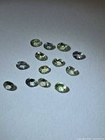 Multiple views of the faceted oval lemon-lime tanzanite