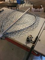 Rod, reel, and landing net on table