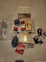 Overview of reels, tackle boxes, line spool, lures, sinkers, net