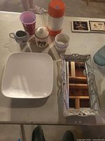 Group showing mirror, Thermos, square plate, small vessels, cups