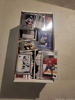 Top view of two-row storage box filled with stacks of hockey cards, memorabilia patch card visible