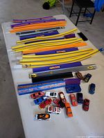 Table view showing multiple colored track pieces and group of die-cast cars