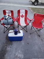 Full lot showing chairs, cooler, percolator, axe, sleeping bag