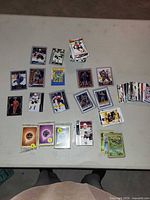 overview of assorted sleeved and loose sports and Pokémon cards on table