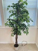Full view of artificial ficus tree showing foliage and planter
