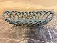 top view of medium blue ceramic open-weave footed fruit bowl