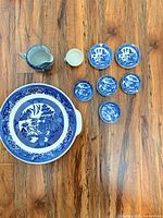 Entire set laid out: platter, creamer, teacup, six saucers