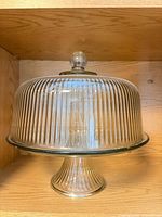 Cake stand assembled with dome in place showing ribbed pattern