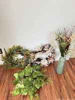 Group shot of three wreaths and floral vase arrangement