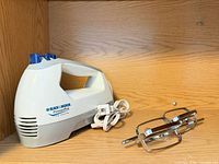 Black & Decker PowerPro hand mixer body, cord coiled, placed on shelf