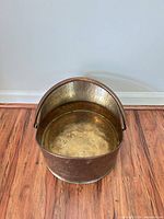 Top view of hammered metal bucket showing interior finish and handle