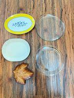 Top view of five platters laid on wood floor