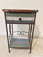 Front view of accent table showing drawer, top and shelf