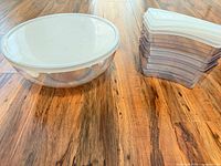 Large bowl and stack of four small containers side by side