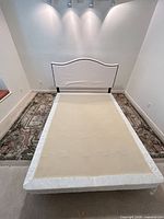 Full bed frame front view showing curved headboard and platform base