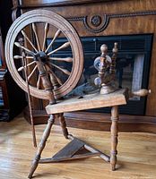 Full view of spinning wheel showing drive wheel, treadle and frame