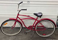 Left side view of entire red Beachcomber cruiser bicycle showing frame, wheels, fenders