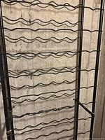 Detail of metal frame and wavy supports showing rust wear